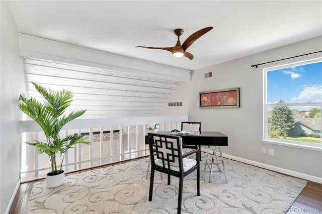 a view of a livingroom with furniture and a potted plant