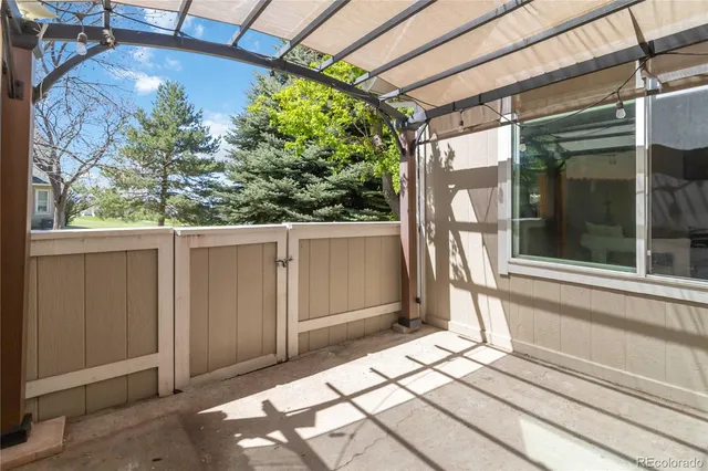 a view of a porch with a table and chairs