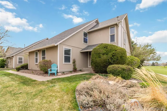 a front view of a house with a yard outdoor seating and garage