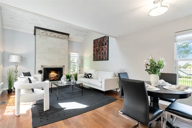 a living room with furniture a table and a fireplace