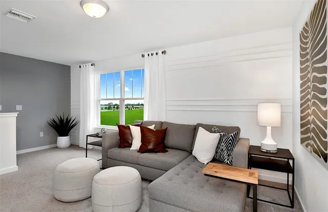 a living room with furniture and a large window