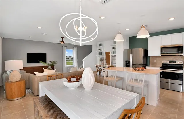 a large kitchen with a table chairs and a wooden floor