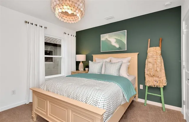 a bed sitting in a bedroom next to a window