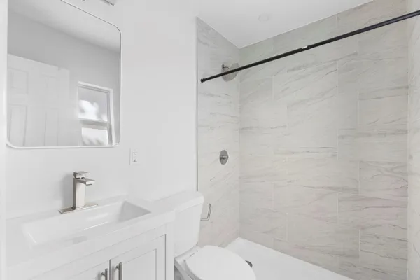 a bathroom with a toilet a sink a shower and vanity