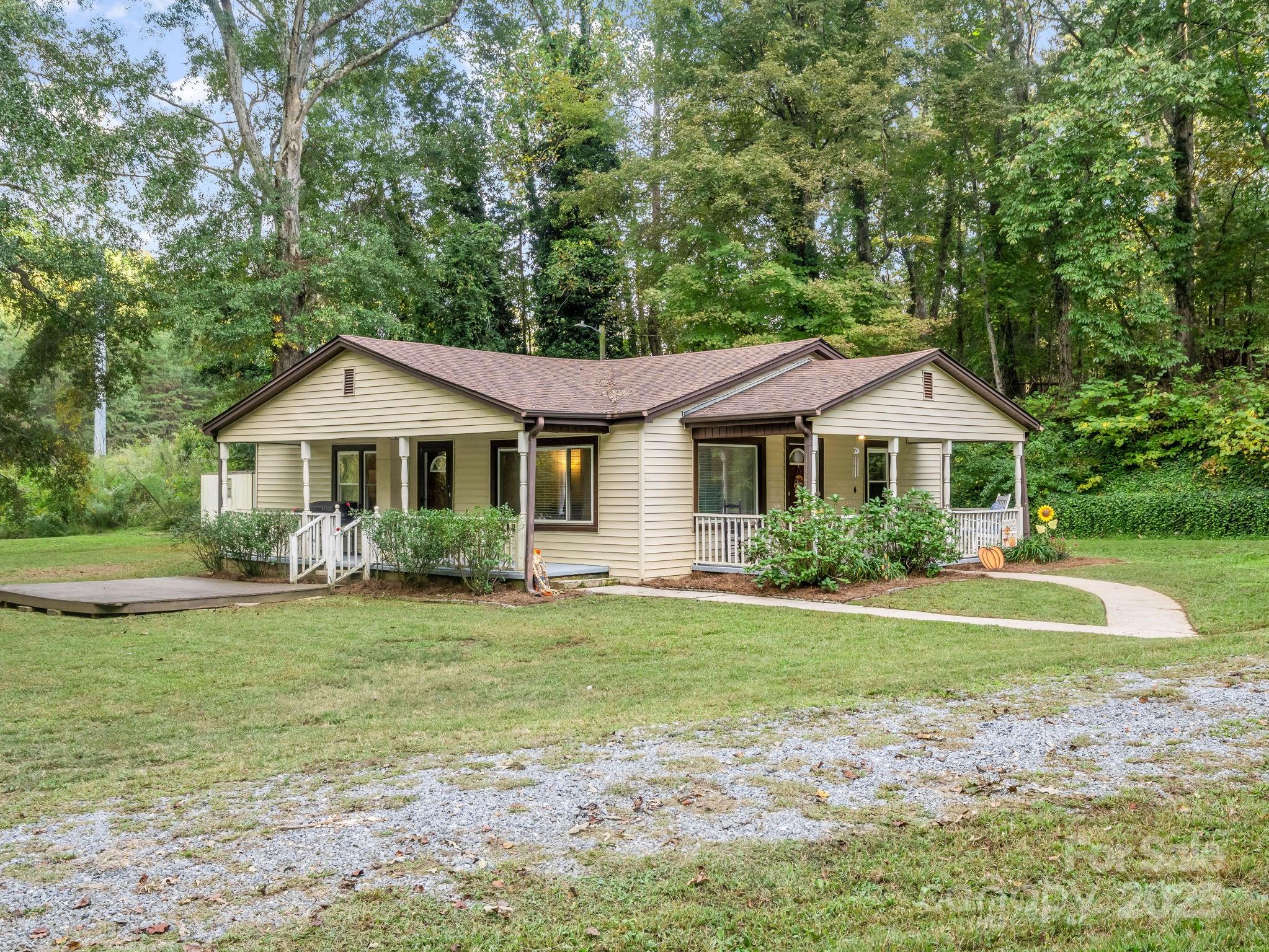 a front view of a house with a yard and trees