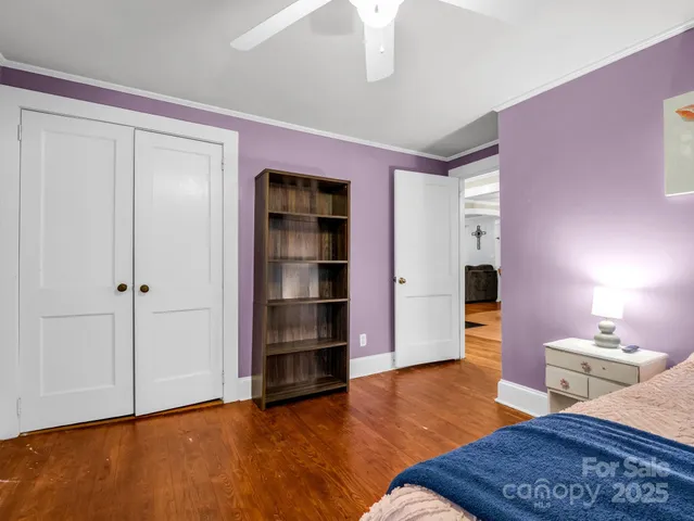 a bedroom with furniture and a wooden floor