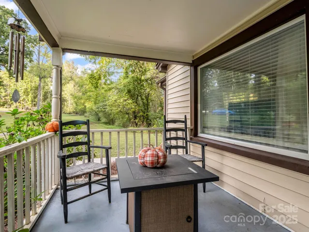 a view of a balcony with table and chairs