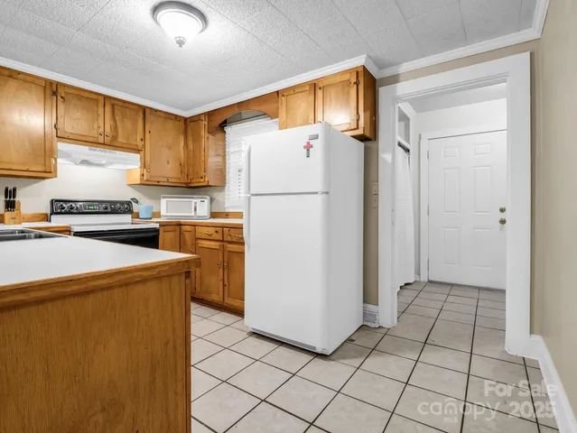 a kitchen with a refrigerator a stove top oven a sink and dishwasher