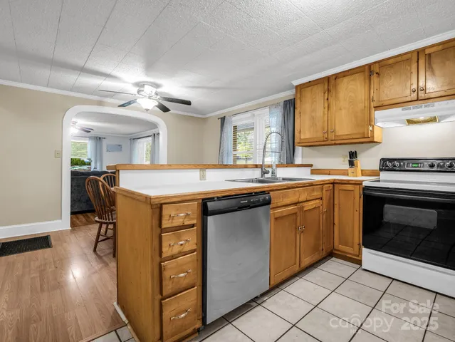a kitchen with a sink stove and cabinets
