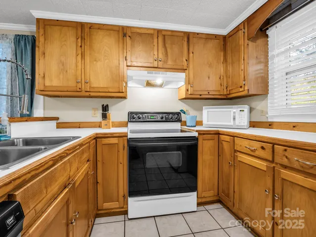 a kitchen with a sink stove and cabinets