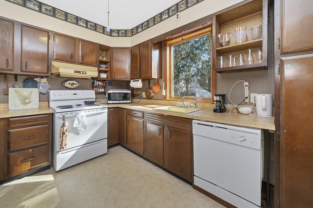 60 Virginia Road Waltham, MA 02453 - Photo 7 of 19 a kitchen with stainless steel appliances granite countertop a stove sink and cabinets