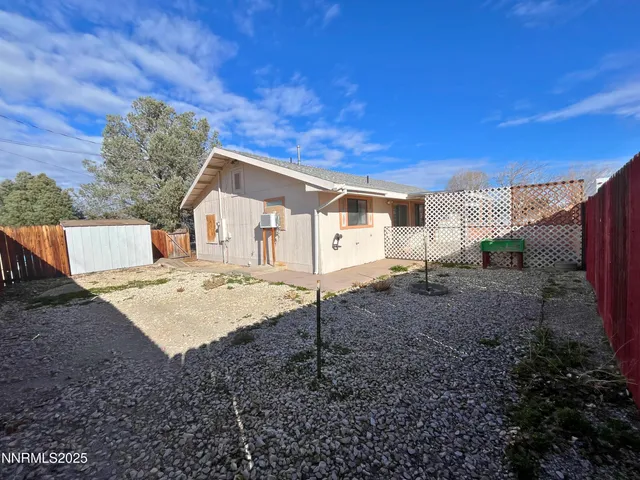 a view of a backyard with wooden fence