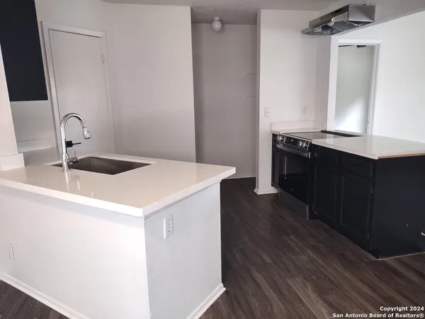 a kitchen with a sink and a refrigerator