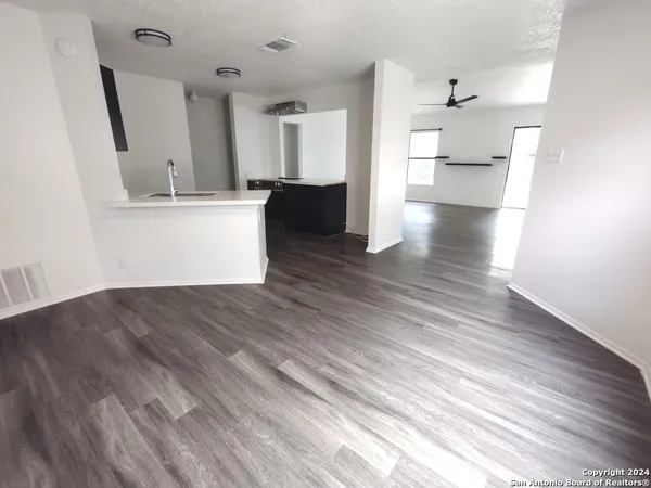 a view of a kitchen with wooden floor