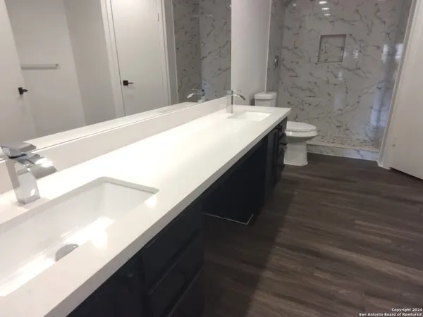 a bathroom with a sink and a large mirror