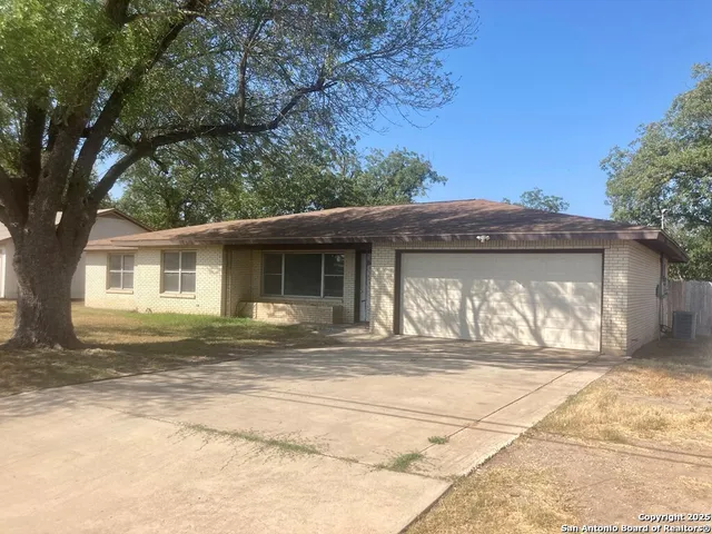 a view of a house with yard and sitting area