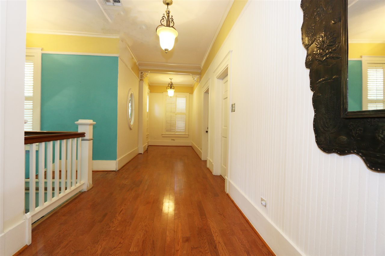 1619 Matamoros Street Laredo, TX 78040 - Photo 11 of 20 a view of a hallway with wooden floor and chandelier