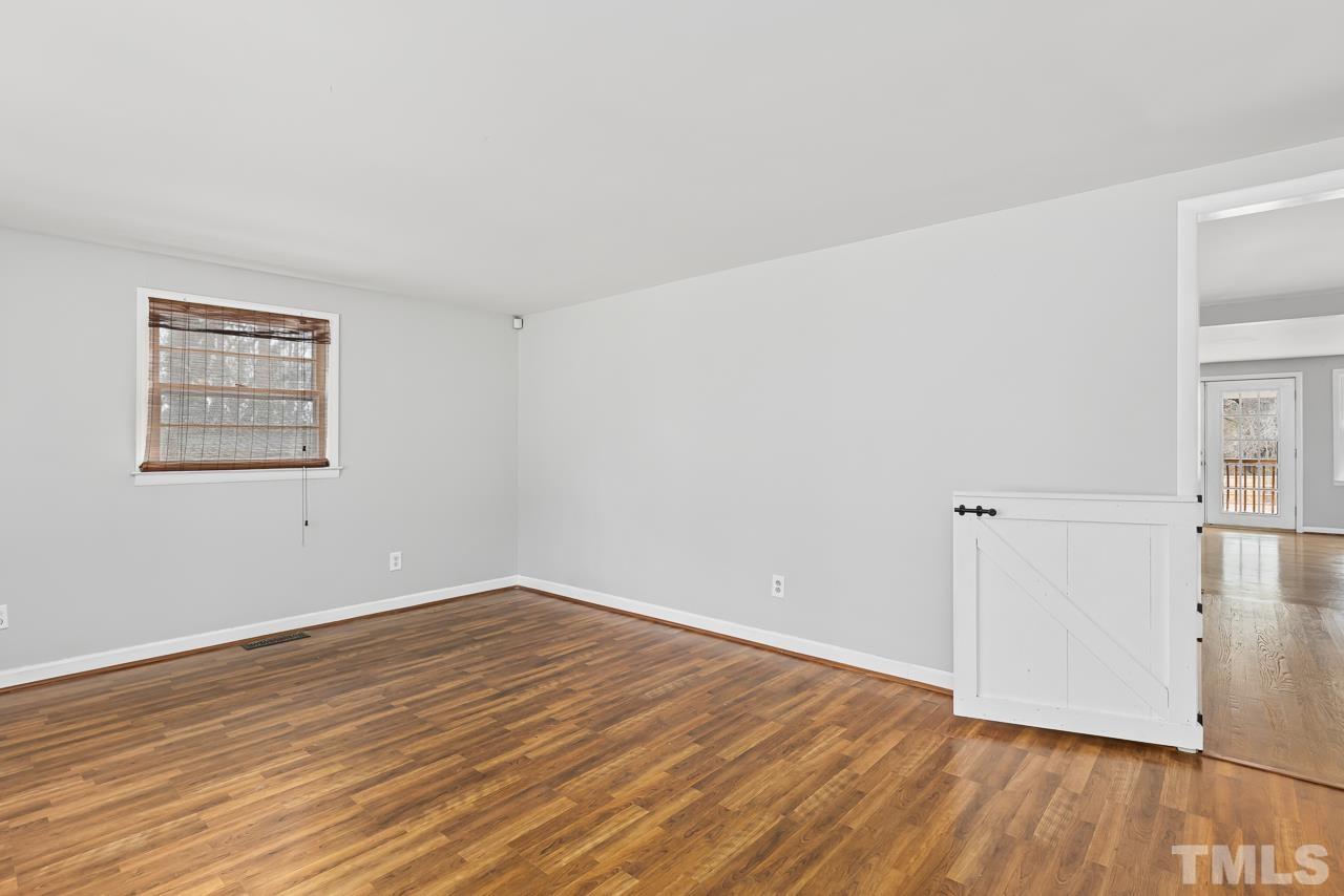 1314 Dowling Road Raleigh, NC 27610 - Photo 11 of 34 an empty room with wooden floor and windows