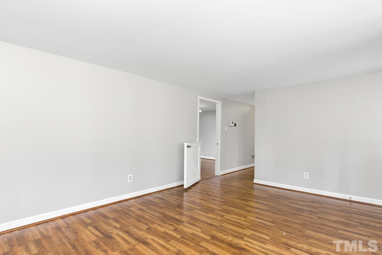 1314 Dowling Road Raleigh, NC 27610 - Photo 12 of 34 a view of an empty room with wooden floor