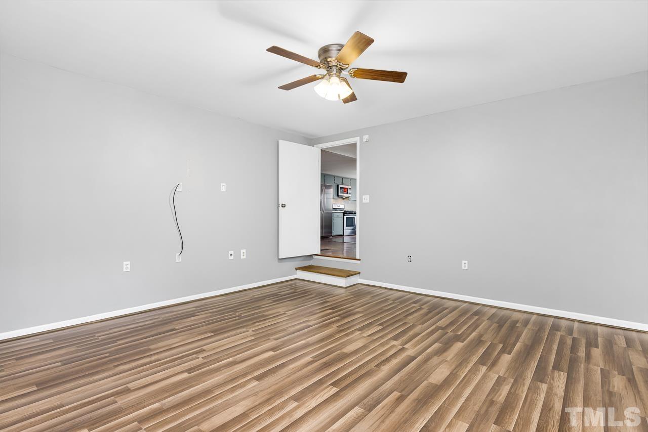 1314 Dowling Road Raleigh, NC 27610 - Photo 14 of 34 wooden floor in an empty room with a window