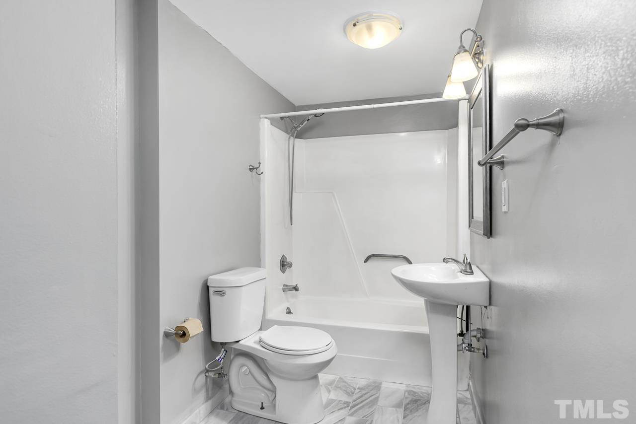 1314 Dowling Road Raleigh, NC 27610 - Photo 19 of 34 a bathroom with a toilet sink and shower