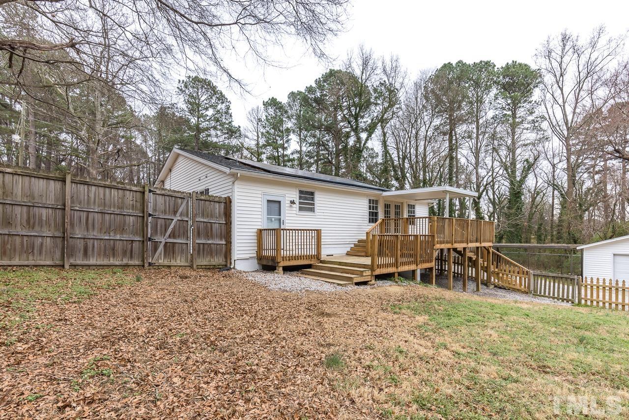 1314 Dowling Road Raleigh, NC 27610 - Photo 31 of 34 a view of a house with a yard and a wooden bench