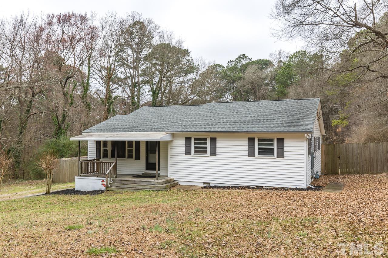1314 Dowling Road Raleigh, NC 27610 - Photo 33 of 34 a front view of a house with a yard tree and outdoor seating
