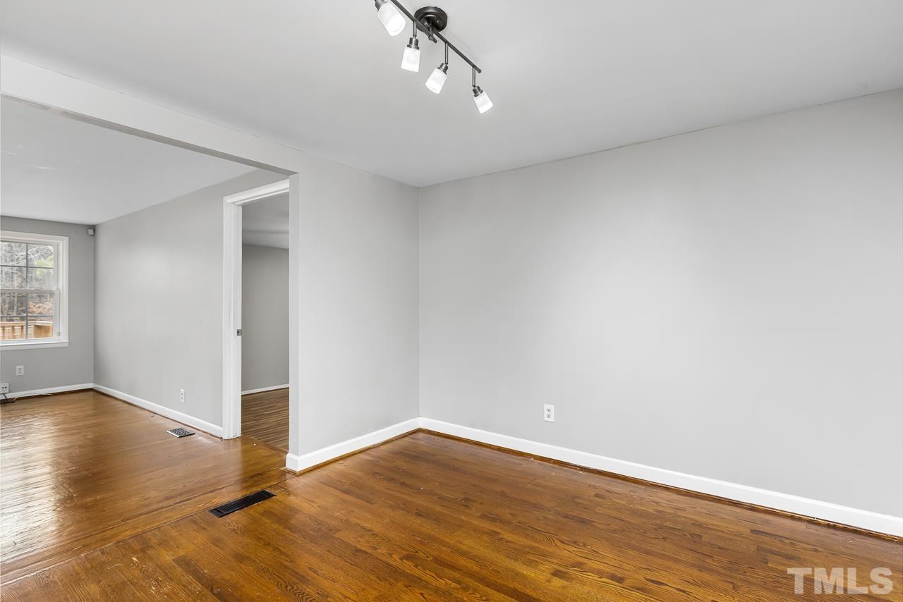 1314 Dowling Road Raleigh, NC 27610 - Photo 4 of 34 wooden floor in an empty room with a window