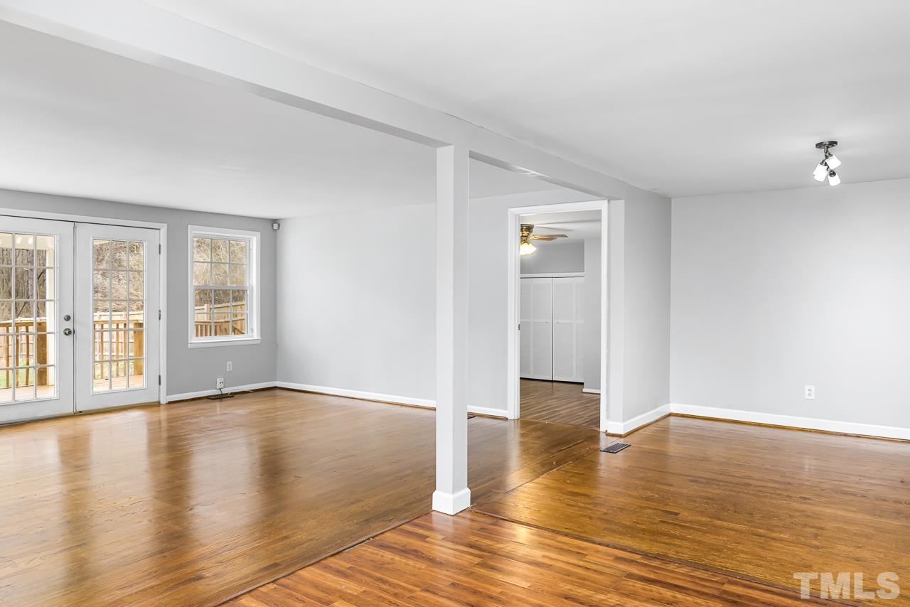 1314 Dowling Road Raleigh, NC 27610 - Photo 5 of 34 a view of an empty room with wooden floor and a window