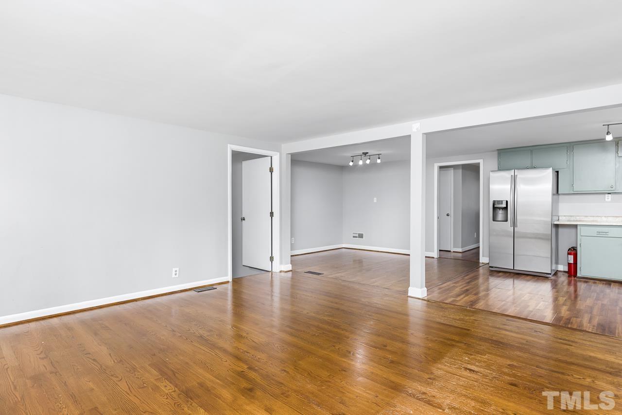 1314 Dowling Road Raleigh, NC 27610 - Photo 6 of 34 a view of empty room with wooden floor