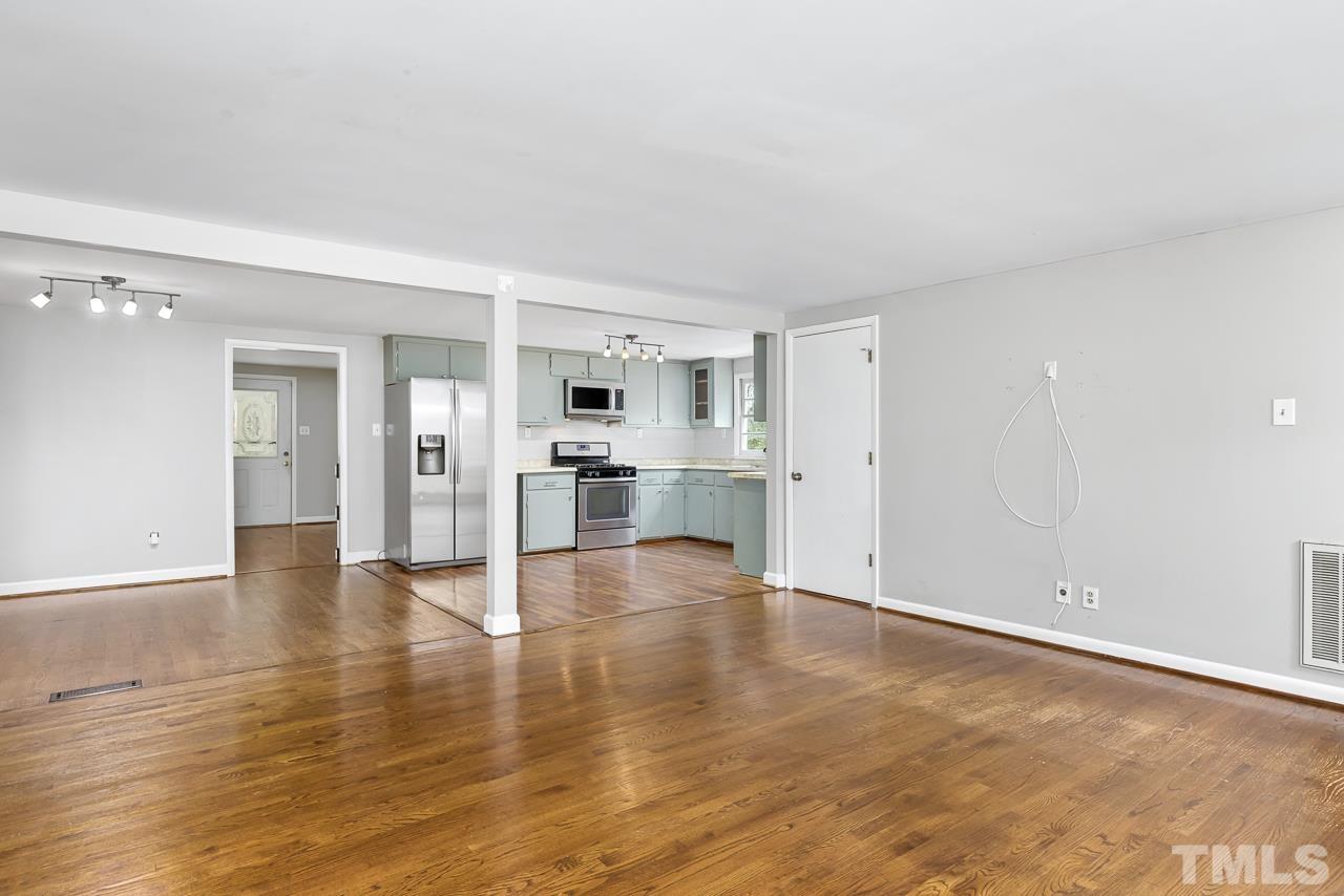 1314 Dowling Road Raleigh, NC 27610 - Photo 7 of 34 a view of empty room with wooden floor