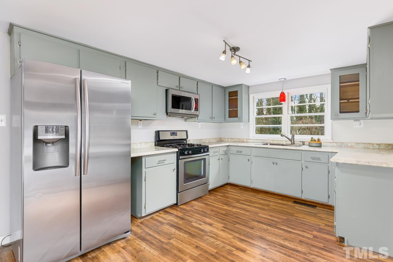 1314 Dowling Road Raleigh, NC 27610 - Photo 9 of 34 a kitchen with cabinets stainless steel appliances and window