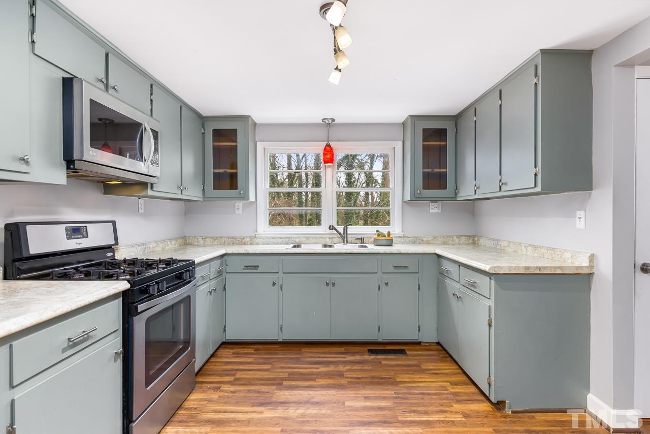 1314 Dowling Road Raleigh, NC 27610 - Photo 10 of 34 a kitchen with stainless steel appliances granite countertop a sink and a stove