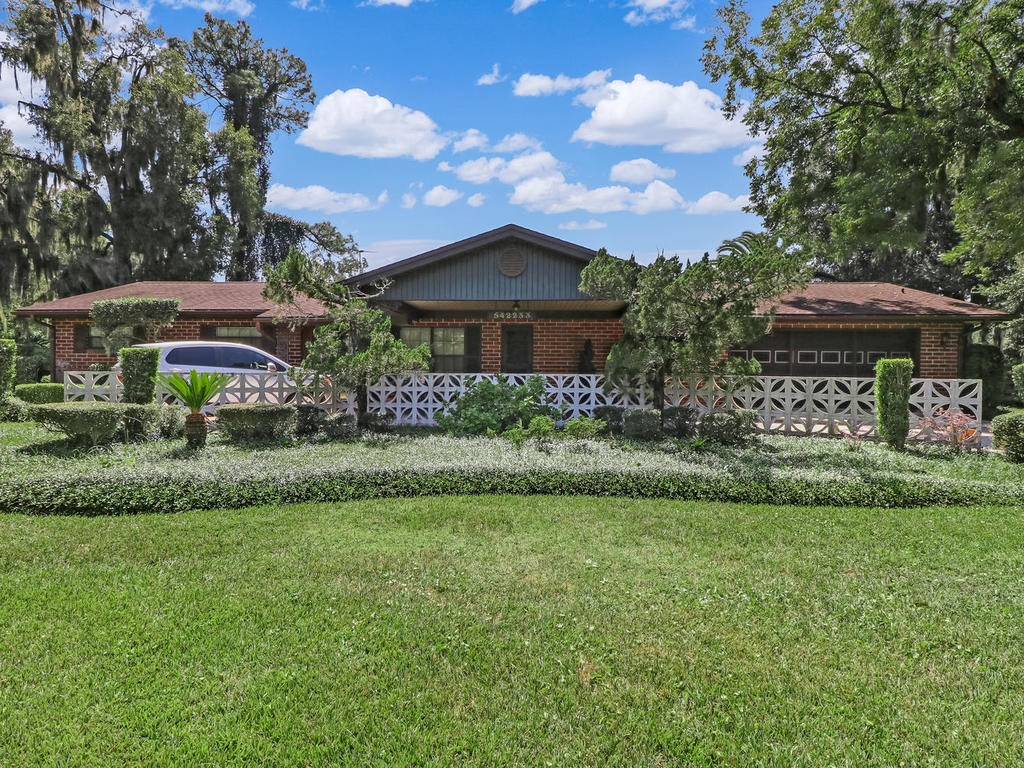 542233 Lem Turner Road Callahan, FL 32011 - Photo 1 of 31 a front view of a house with a yard