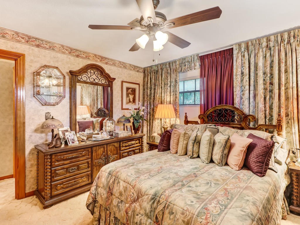 542233 Lem Turner Road Callahan, FL 32011 - Photo 19 of 31 a bedroom with a bed and a chandelier