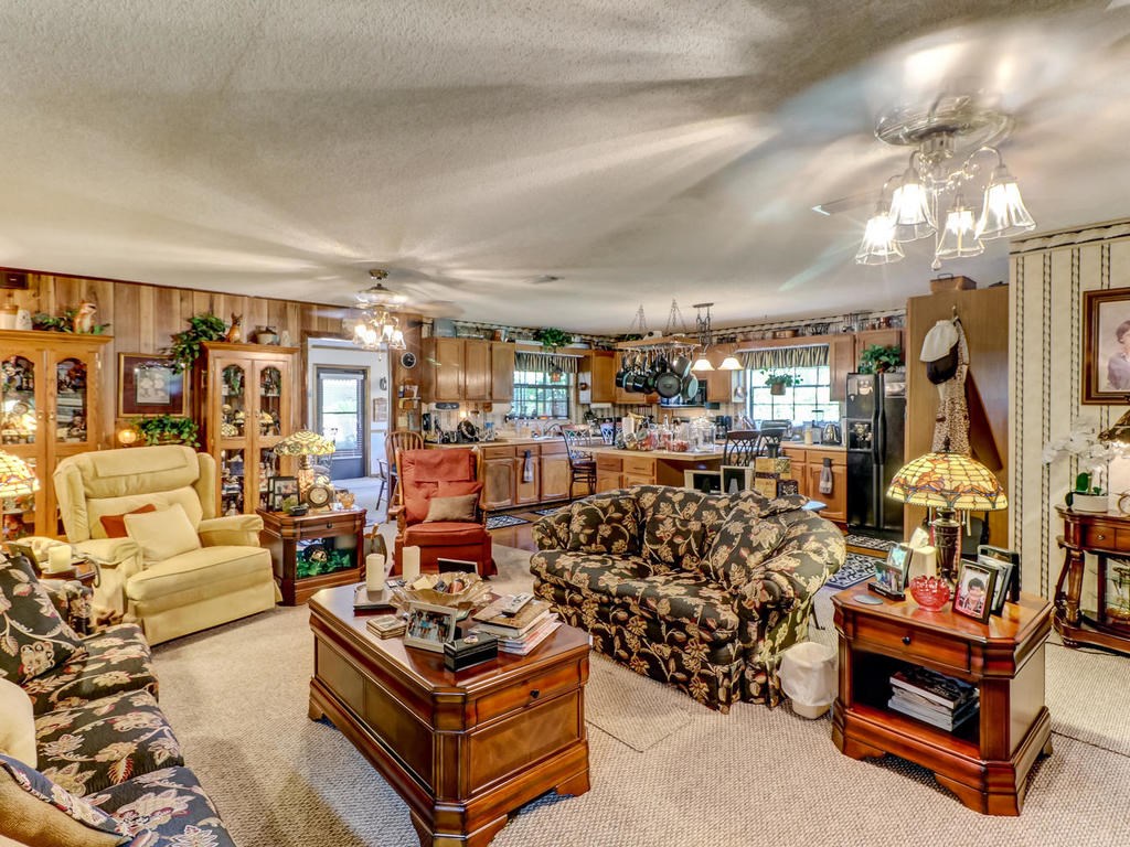 542233 Lem Turner Road Callahan, FL 32011 - Photo 25 of 31 a living room with lots of furniture and a chandelier
