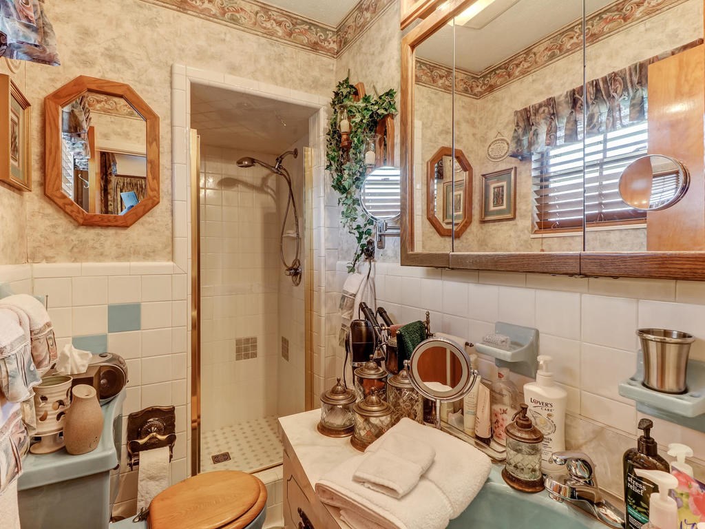 542233 Lem Turner Road Callahan, FL 32011 - Photo 6 of 31 a bathroom with a toilet a sink and mirror