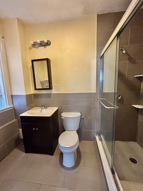 11 Raven Street, Unit 2 Boston, MA 02125 - Photo 4 of 10 a bathroom with a sink and a mirror