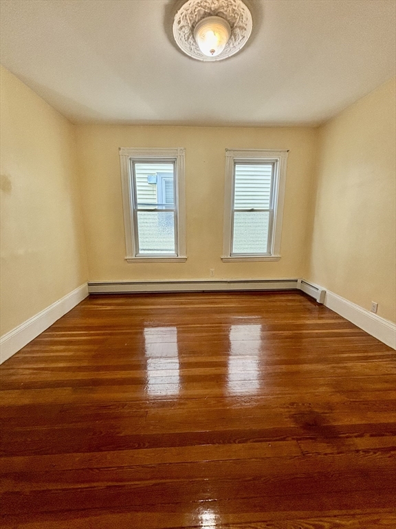 11 Raven Street, Unit 2 Boston, MA 02125 - Photo 8 of 10 a view of empty room with wooden floor and window