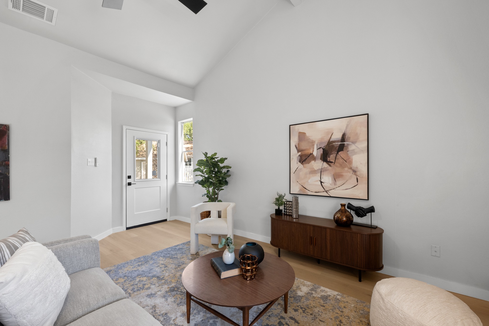 6501 Brush Country Road, Unit 120 Austin, TX 78749 - Photo 2 of 26 Living area featuring a vaulted ceiling and light LVP flooring