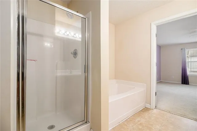 a bathroom with a bathtub and shower