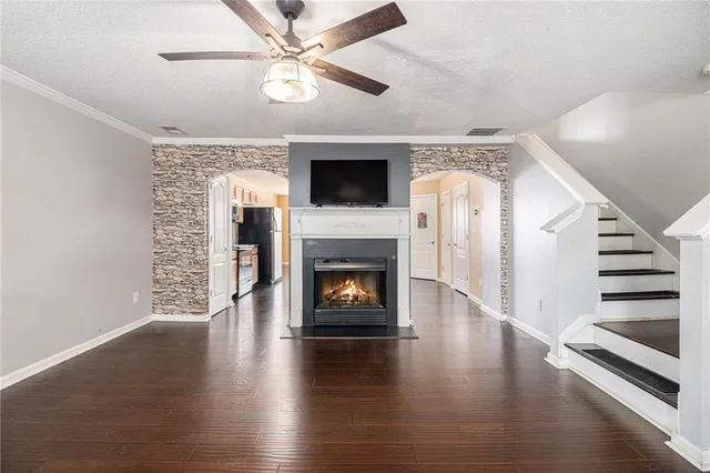 a living room with wooden floors and a fireplace