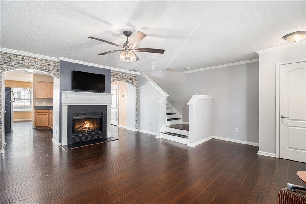 3262 Cascade Parc Boulevard Southwest Atlanta, GA 30311 - Photo 5 of 24 a view of an empty room with wooden floor fireplace and a window