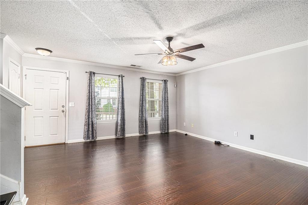3262 Cascade Parc Boulevard Southwest Atlanta, GA 30311 - Photo 6 of 24 an empty room with wooden floor and window