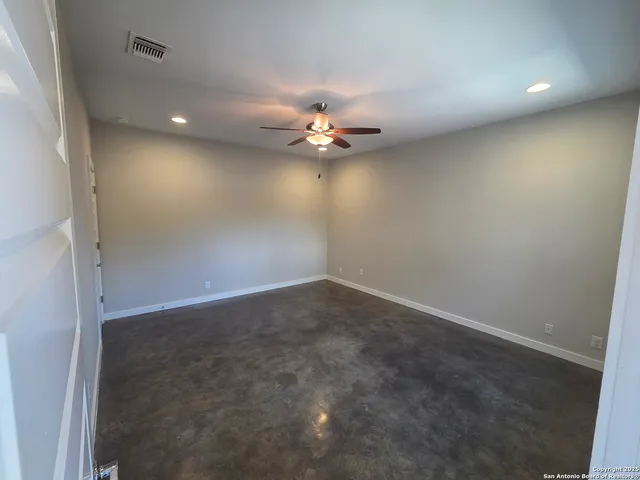 a view of a livingroom with a ceiling fan and window