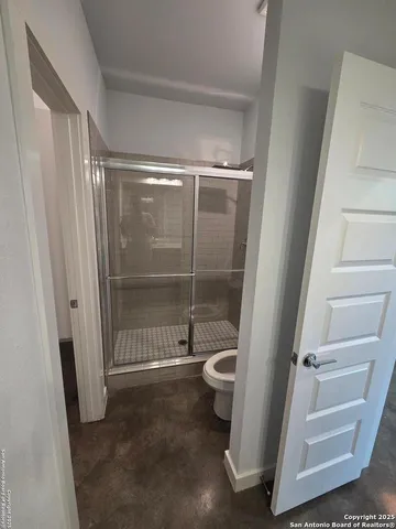 a bathroom with a glass shower door