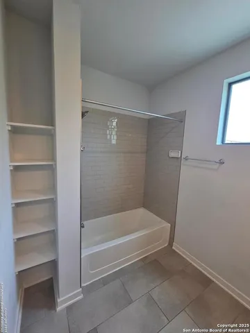 a spacious bathroom with a toilet sink and mirror