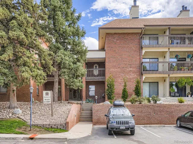 front view of a brick house with a yard