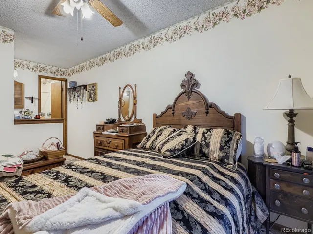a bedroom with bed and a chandelier