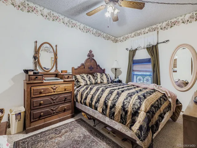 a living room with furniture kitchen view and a window